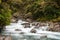 Mountainous Monkey creek flowing through impressive landscape next to Milford Sound highway, New Zealand