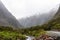 Mountainous Monkey creek flowing through impressive landscape next to Milford Sound highway, New Zealand