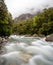 Mountainous Monkey creek flowing through impressive landscape next to Milford Sound highway, New Zealand