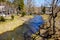 Mountainous river flowing through small village. Early spring