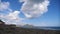 Mountains against the blue sky with white clouds. Cirrus clouds run across the blue sky. The best views of the coast