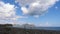 Mountains against the blue sky with white clouds. Cirrus clouds run across the blue sky. The best views of the coast