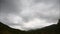 Mountains in the background of gray clouds. Dark clouds envelop the tops of the mountains. Taymlaps