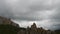 Mountains in the background of gray clouds. Dark clouds envelop the tops of the mountains. Time Lapse. Motion in the