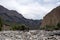 Mountains cliff with erroded soil. Wild outdoor landscape. Adventure tourism.