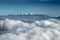 Mountains covered in snow and clouds in valley. Background photo