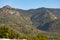 Mountains. Desert of Las Palmas seen from the town of Benicasim, in CastellÃ³n. Mountainous and rocky system with green trees