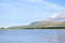 Mountains distant ocean bridge water ripples blue skies clouds limavady binevenagh