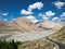 Mountains and flowing Shyok river with white clouds in blue sky background on way to Diskit in Nubra valley, Leh