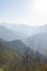 Mountains foggy white blue sky. Chinese autumn mountains.