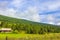 Mountains forests and farmhouses in green meadows norwegian landscape Norway