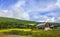 Mountains forests and farmhouses in green meadows norwegian landscape Norway