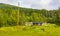 Mountains forests and farmhouses in green meadows norwegian landscape Norway