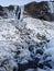 Mountains frozen with ice in winter. Earth, stones are covered with ice