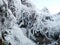 Mountains frozen with ice in winter. Earth, stones are covered with ice