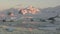 Mountains and glaciers of the Antarctic Peninsula in the rays of the setting sun