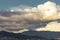 Mountains with homes cloudscape with cumulus, nimbus clouds with blue sky