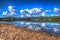 Mountains and lake with clear water on a calm still summer day in Ullswater the Lake District