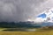 Mountains lake overcast storm clouds sunlight