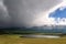 Mountains lake overcast storm clouds sunlight