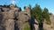 Mountains landscape with majestic rock formations and evergreen trees.