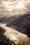 Mountains landscape in orange toned colors around Rijeka Crnojevica river curve from high view in overcast day with dramatic sky