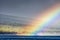 Mountains landscape with rainbow- cloudy sky in pastel colors for your design. Romantic seascape - seaside view with