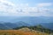 Mountains with many peaks, forest and views of the cloudy sky