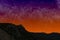 Mountains at night on the background of starry sunset sky