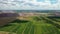 Mountains of products for the production of potash salt and a green field.Salt mountains near the city of Soligorsk