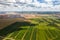 Mountains of products for the production of potash salt and a green field.Salt mountains near the city of Soligorsk.Production of