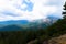 Mountains with rain clouds and fir trees in the Bavella region in Corsica, France.