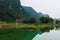 Mountains reflected in ember green lake on the hidden Cat Ba Island, Ha Long Bay