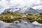 Mountains reflected in a rippled lake in the Swiss Alps, with a