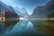 Mountains reflected in water in beautiful lake at sunny morning