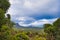 Mountains rising up from a forested plain under a cloudy sky, Western Australia