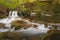 Mountains river and waterfall in springtime