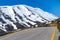 Mountains road wonderland, stunning steep slopes, cliffs and snow-capped rocky peaks