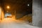 Mountains of sand in a cement factory in a Dark room with light from the lanterns