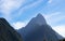 Mountains in silhouette leading to famous landmarks that attracts tourists, Mitre Peak projecting skyward