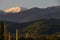 Mountains and slopes of the Trans-Ili Alatau, rising above the houses, during the summer sunrise.