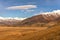 Mountains steppe aerial view autumn snow clouds