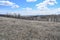 The mountains, steppes, snow, bushes, grass and cloudy sky. Volga River. Spring landscape