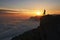 Mountains sunset landscape with tourist silhouette in orange sun light