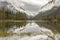 mountains surrounded by clouds with reflection