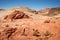 Mountains surrounding Fire wave during wonderful sunny day with blue sky, in Valley of Fire State Park, Nevada