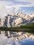 Mountains and tent reflecting in lake