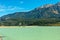 Mountains tower over Lajoie Dam on Downton Lake near Gold Bridge in British Columbia, Canada