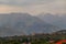 Mountains of the Trans-Ili Alatau in the distance above a residential area in cloudy weather