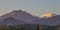 The mountains of the Trans-Ili Alatau during the summer sunrise, the peaks of which are painted in orange.